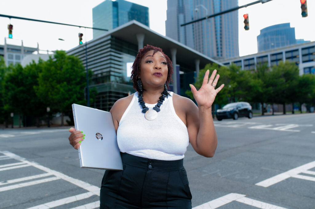 excited black woman standing in the emty city streets